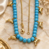 Oro Laminado Pendant Necklace, Gold Filled Style Dolphin and Rat Tail Design, Blue Resin Finish, Golden Finish, 04.32.0008.3.18 (18 Inches Length)