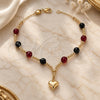 Oro Laminado Charm Bracelet, Gold Filled Style Heart and Ball Design, with Black Azavache and Garnet Pearl, Multicolor Polished, Golden Finish, 03.32.0187.07 (03 MM Thickness, 7 Inches Length)