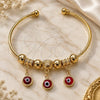 Oro Laminado Individual Bangle, Gold Filled Style Evil Eye Design, with Garnet Crystal, Polished, Golden Finish, 07.93.0012 (02 MM Thickness, One size fits all)