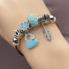 Stainless Steel Individual Bangle, Suitecase and Leaf Design, with Crystal and Turquoise Crystal, Turquoise Enamel Finish, Rhodium Finish, 07.454.0011 (03 MM Thickness, One size fits all)